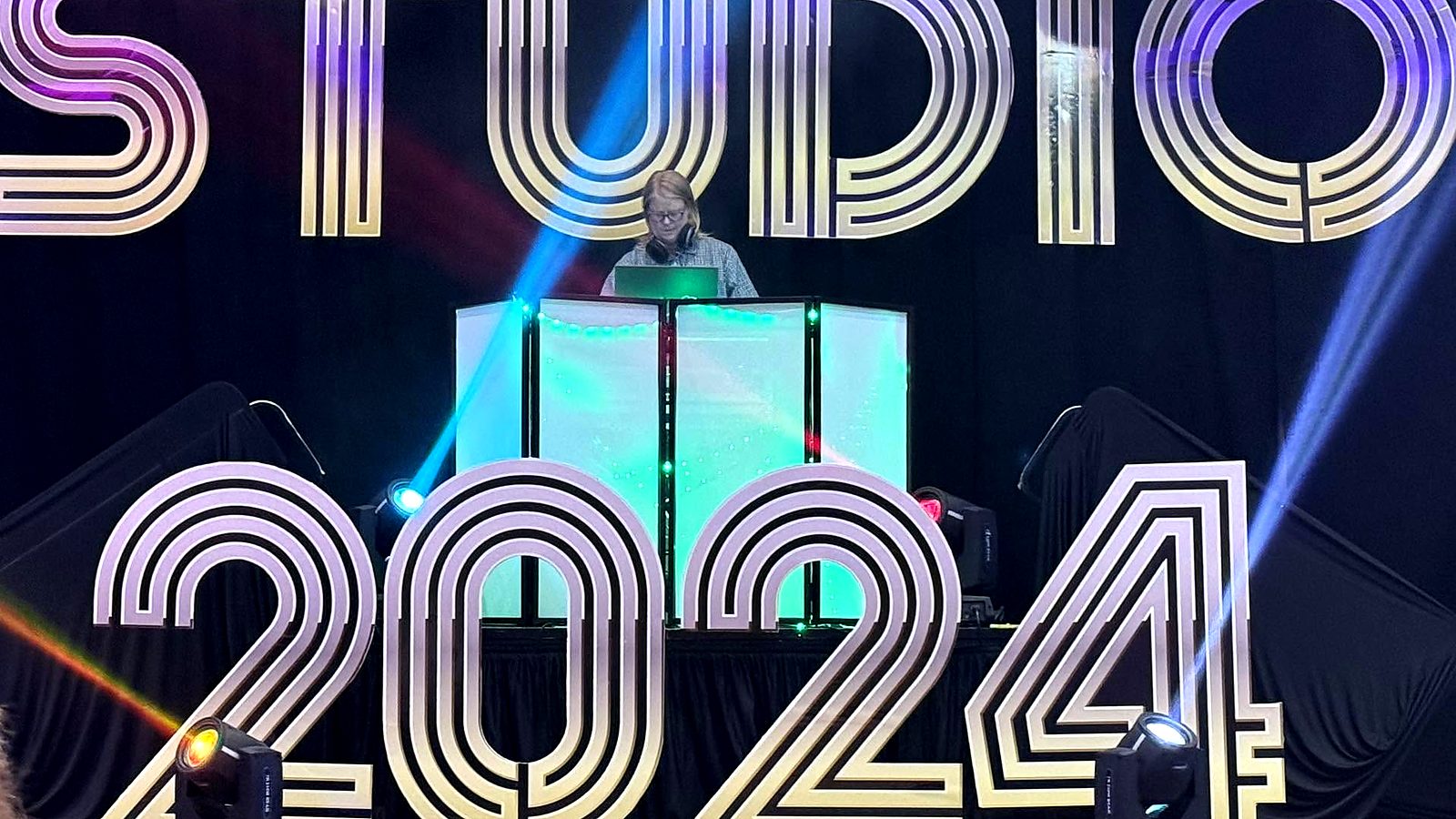 Hollie DJing on stage at a Studio 2024 themed event