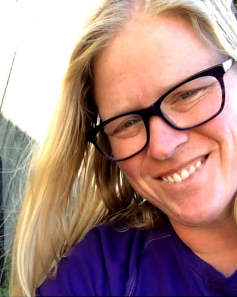 Hollie smiling in glasses and an LSU purple shirt